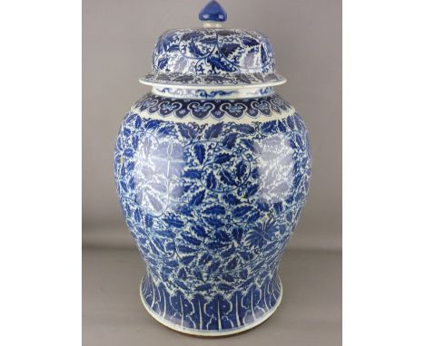 A LARGE CHINESE BLUE &amp; WHITE TEMPLE JAR &amp; COVER, with all over painted leaf and floral design, the domed lid with kno