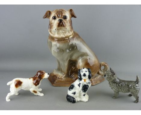 FOUR POTTERY DOG FIGURINES including a large seated pug with glass eyes, a Beswick spaniel, a Goebel terrier and a vintage se