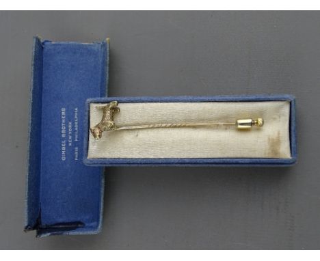 A PRESUMED GOLD SCOTTIE DOG STICK PIN in Gimbel Brothers, New York box (formerly set with presumed precious stone eye), 3.3 g