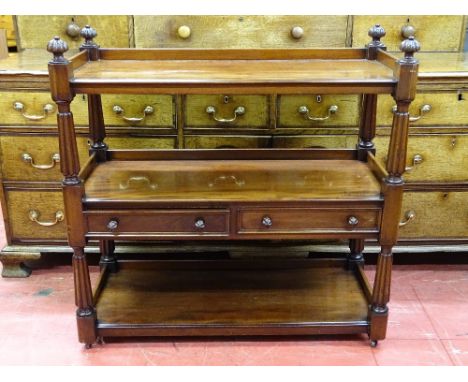 A REGENCY MAHOGANY THREE TIER DUMB WAITER with twin central drawers and carved reeded detail and finial caps, 102 cms high, 1
