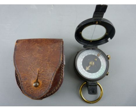 A LEATHER ENCASED MILITARY-STYLE BLACK METAL &amp; BRASS POCKET COMPASS (no maker's mark visible)