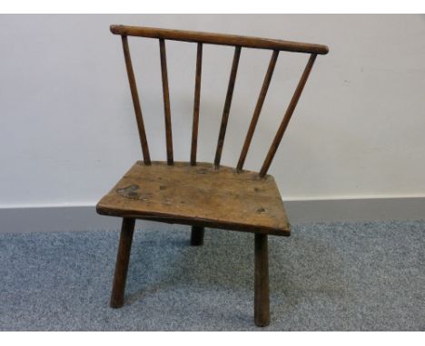 PRIMITIVE WELSH STICK CHAIR on three turned legs and with a six spindle back