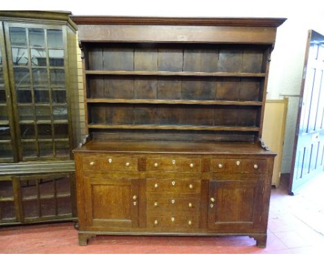 A 19th CENTURY OAK NORTH WALES DRESSER with three shelf rack over a 'T' arrangement of six pine lined opening drawers and two
