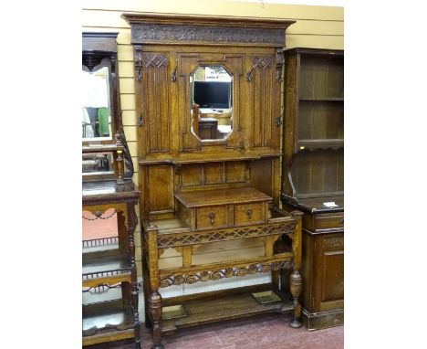 AN EXCELLENT JACOBEAN STYLE OAK MIRRORED HALLSTAND with carved and pierced rail detail, single drawer glove box and base shel