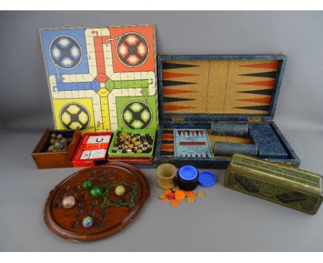 A COLLECTION OF VINTAGE BOARD GAMES including a Victorian mahogany solitaire board with a quantity of early marbles and H R G