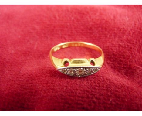 A LADY'S EIGHTEEN CARAT GOLD DRESS RING with five tiny diamonds, 2.4 grms, size O