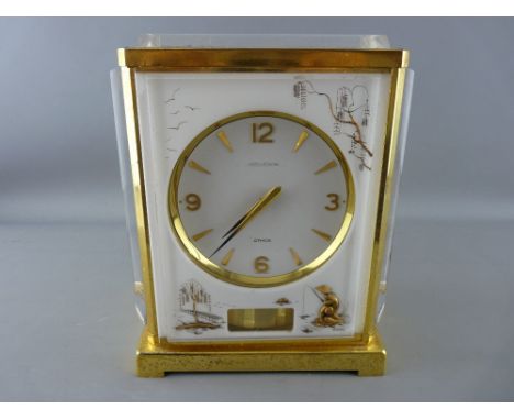 A JAEGER LE COULTRE ATMOS MARINA MANTEL CLOCK, gilt brass frame and plexi glass panels with white backgrounds and gilt chinoi