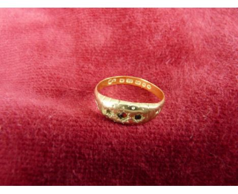 A TWENTY TWO CARAT GOLD LADY'S DRESS RING with three tiny rubies (one missing), 2 grms