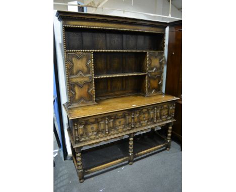 Oak dresser, two shelf delft rack incorporating doors, bobbin moulded outlines, the base with two deep frieze drawers, each w