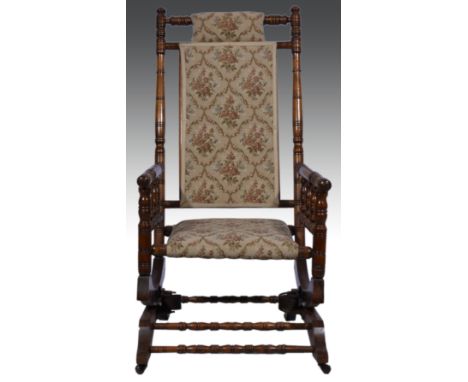American stained wood rocking chair, tapestry style upholstery, width 56cm.