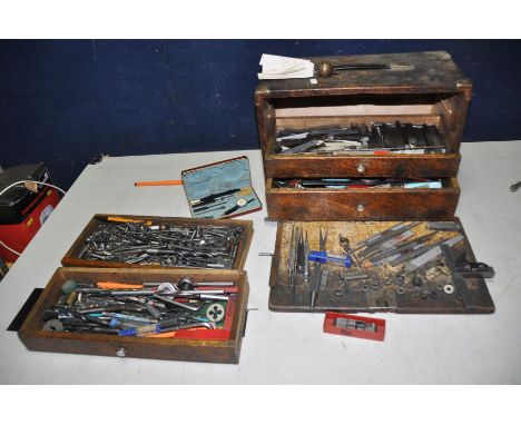 AN ENGINEERS TOOL CHEST OF FOUR DRAWERS containing engineering tools including reamers, marking equipment, taps, dies, tap an