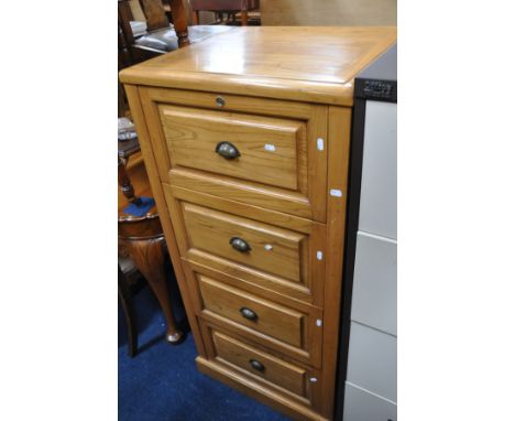 A LIGHT WOOD FOUR DRAWER FILING CABINET