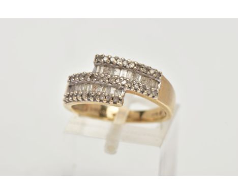 A 9CT GOLD DIAMOND DRESS RING, of a cross over design, set with rectangular cut and single cut diamonds, stamped diamond weig