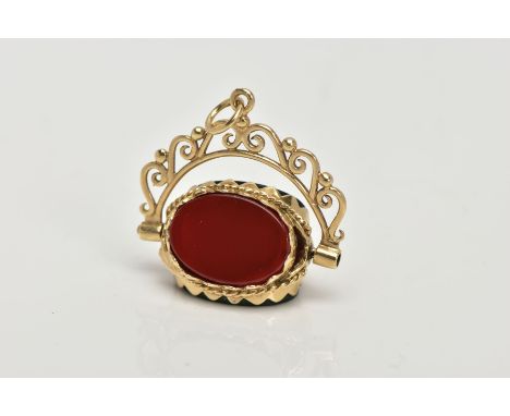 A 9CT GOLD SWIVEL FOB, set with oval cut onyx, carnelian and bloodstone panels, openwork scroll mount, fitted with a jump rin