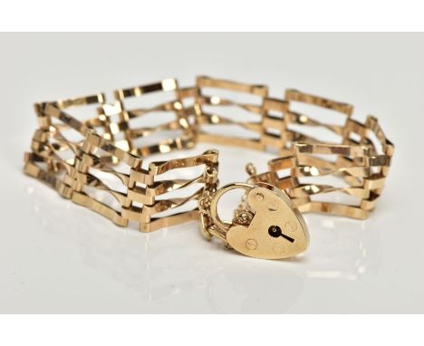 A 9CT GOLD GATE BRACELET,  four bar polished yellow gold gate bracelet, fitted with a heart padlock and safety chain, approxi