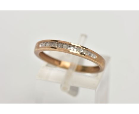 A 9CT GOLD DIAMOND HALF ETERNITY RING, designed with a row of channel set single cut diamonds, stamped diamond weight 0.10cts