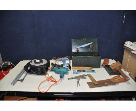 A METAL BOX CONTAINING TOOLS including mole grips, back saw, mallet, hammers, an untested Black and Decker drill, an untested