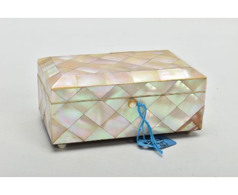 A MOTHER OF PEARL TRINKET BOX, of rectangular form, with hinged lid, pale blue lined interior, supported on four bun feet, wi