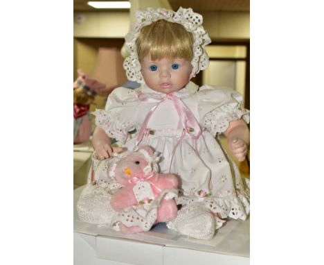 FOUR BOXED DANBURY MINT COLLECTORS DOLLS, each has its own toy and certificate, dolls are soft bodied with porcelain head and