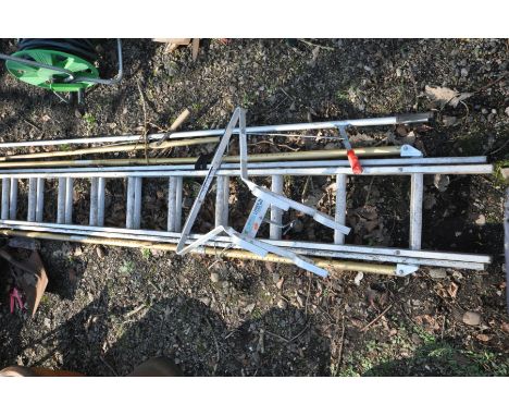 AN ALUMINIUM DOUBLE EXTENSION LADDER, and ladder stand-off, along with a selection of garden tools to include two long reach 
