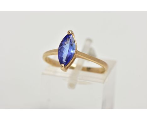 A 9CT GOLD TANZANITE RING, designed with a marquise cut tanzanite, approximate dimensions length 11.6mm x width 4.9mm, leadin