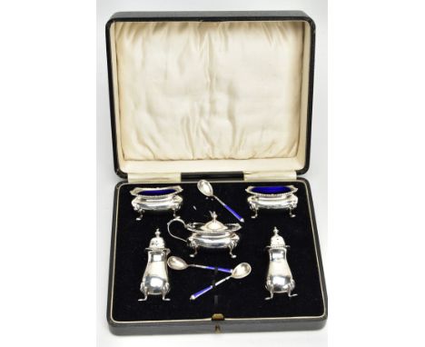 AN EARLY 20TH CENTURY FIVE PIECE SILVER CONDIMENT SET, comprising of two salts each with a blue glass insert, two pepperettes