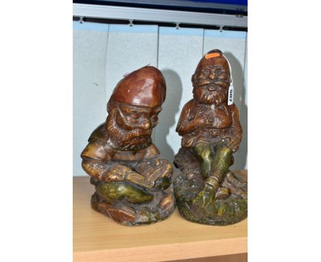 TWO CAST CONCRETE GARDEN GNOMES, one is a jovial laughing figure, the other is reading a book, tallest approximately 27cm, bo