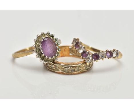 TWO 9CT GOLD GEM SET RINGS AND ONE OTHER, the first a cluster ring centring on an oval cut amethyst within a surround of sing