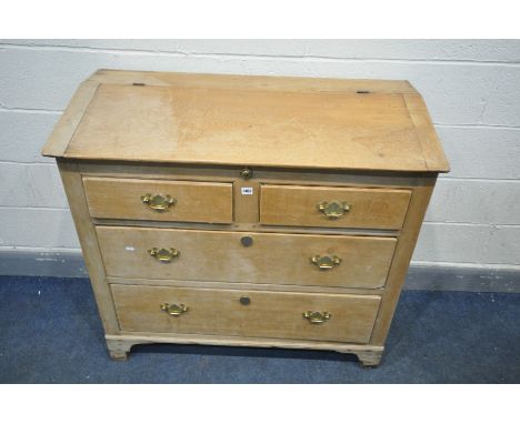 A PINE SIDE CABINET incorporating 19th century timbers, with a hinged top enclosing an arrangement of drawers and a writing s