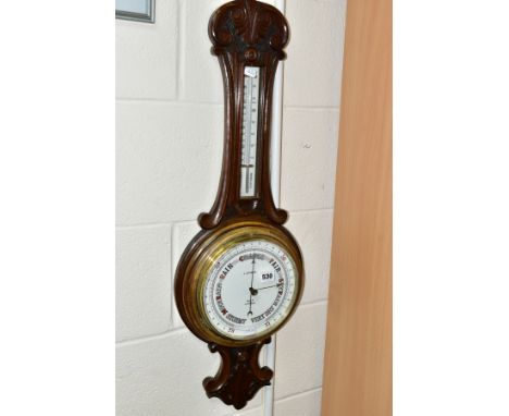 A LATE VICTORIAN WALNUT STAINED ANEROID BAROMETER, ceramic centigrade / Fahrenheit scale and dial, retailed by  'J.D. Fisher,