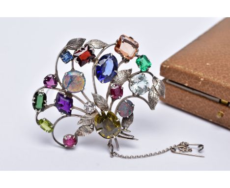 A WHITE METAL FLORAL SPRAY, GEM SET BROOCH, floral spray set with a variety of multi cut gemstones such as garnets, peridot, 