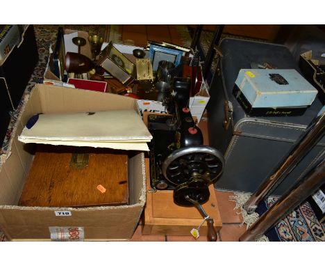 A KENBAR CAST IRON SEWING MACHINE, black painted with floral decoration on wooden base, with a boxed Bell &amp; Howell Model 