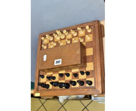 A MID 20TH CENTURY WOODEN CHESS BOARD AND CHESS PIECES, the board with lift off top opening to reveal an interior with compar