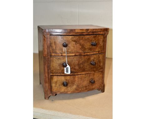 A VICTORIAN BURR WALNUT VENEERED MINIATURE BOW FRONT CHEST OF THREE DRAWERS, turned wooden handles, on later bracket feet, he