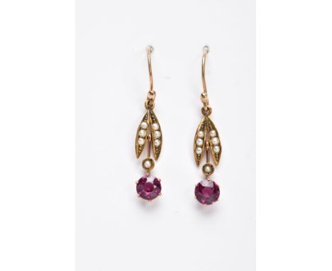 A PAIR OF EDWARDAN, GARNET AND SPLIT PEARL DROP EARRINGS, each yellow metal earring, set with a circular cut garnet, suspendi
