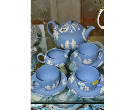 A SMALL COLLECTION OF WEDGWOOD PALE BLUE JASPERWARE, comprising a tea pot and cover and flattened circular form, a cream jug 