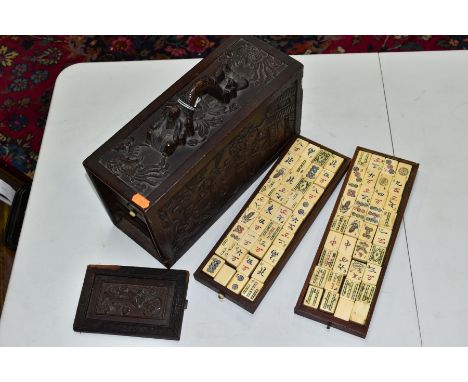A LATE 19TH/EARLY 20TH CENTURY MAH JONG SET, the bone and bamboo playing pieces housed in a relief carved carry case with bir