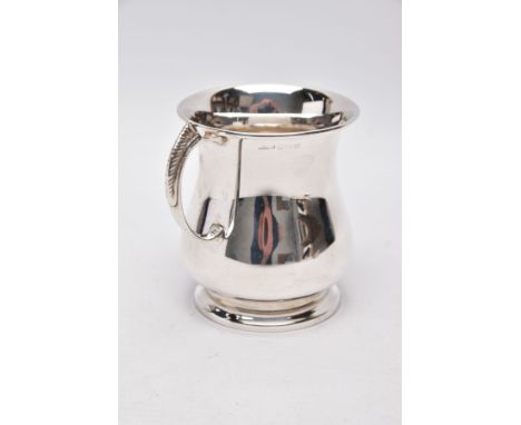 A SILVER TANKARD, bell shaped body with a feather detailed handle, hallmarked 'Roberts &amp; Dore' Birmingham 1974, approxima