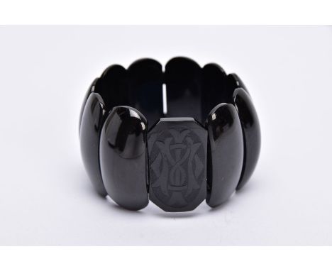 A VICTORIAN JET BRACELET, stretch bracelet, one rectangular shaped link with an engraved monogram, fitted with polished oval 