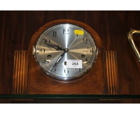 AN OAK MANTEL CLOCK