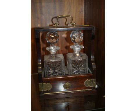 A VINTAGE MAHOGANY TWO DECANTER TANTALUS