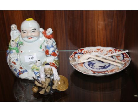 AN ORIENTAL STYLE CERAMIC BUDDHA FIGURE TOGETHER WITH ANOTHER, CLAY PIPES ETC (6)