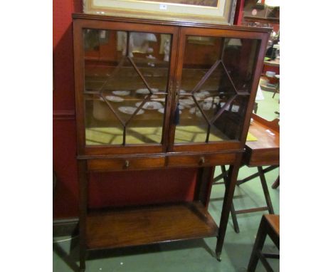 A George III mahogany reeded edge bookcase/cabinet the two astragal glazed doors over two drawers and square tapering legs on