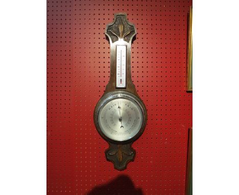 A carved oak banjo barometer 
