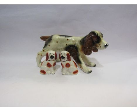 A ceramic figure of a spaniel and a pair of Staffordshire style spaniels  (3)