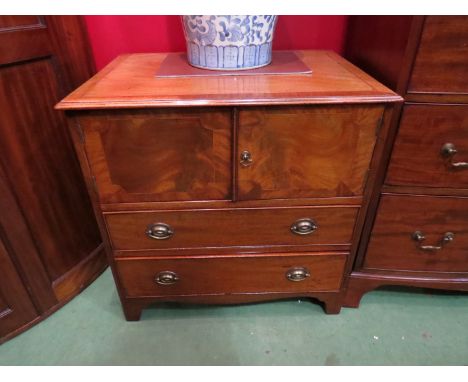 A pair of Georgian style mahogany cabinets, the two doors over twin long drawers, satinwood stringing, on bracket feet