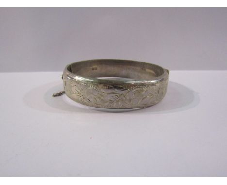 An engraved silver stiff-hinge bangle, 25.5g