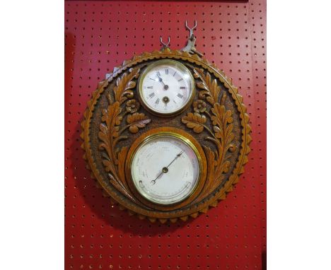 A barometer/clock in carved floral design frame, 31cm diameter
