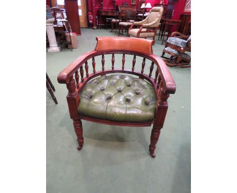 A circa 1900 walnut captain's style desk chair with green buttoned leather upholstery and spindle back, on ring-turned suppor