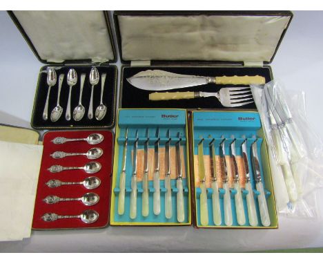 A cased set of six silver spoons, a cased fish knife and fork with silver rim and ivory handles, cased butter cutlery with lo